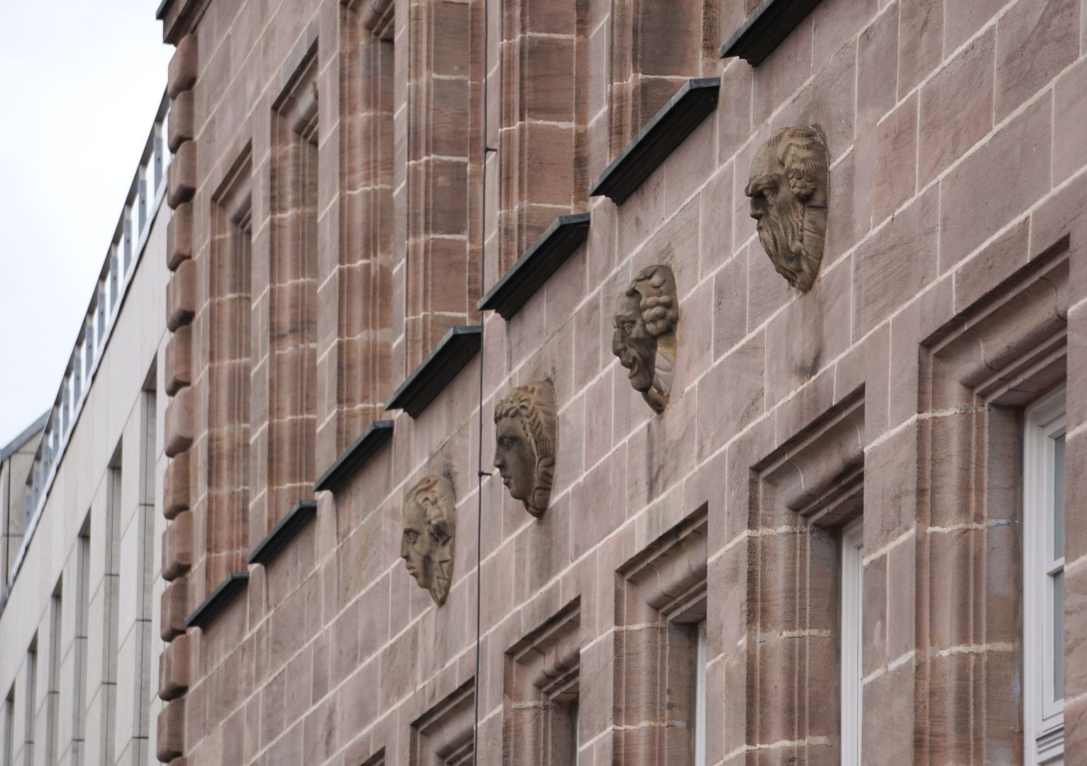 Fassadenschmuck an der ehemaligen AOK / Grillenberger Straße Maskenkopfreihe am nördlichen Gebäudeflügel