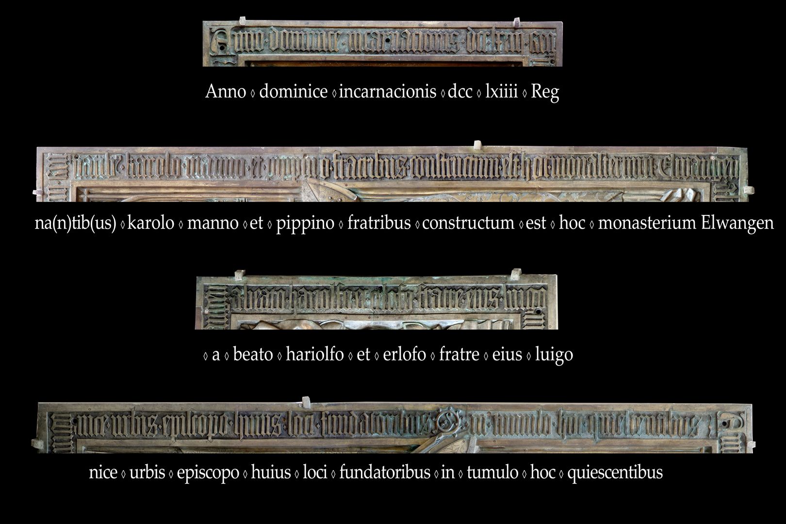 Memorienplatte für Hariolf und Erlolf Im Jahr der Menschwerdung des Herrn 764 als die Brüder Karlmann und Pippin regierten, wurde dieses Kloster Ellw. von den Gründern dieses Ortes, dem selig. Hariolf und seinem Bruder Erlolf, dem Bischof der Stadt Langres, errichtet. Sie ruhen in diesem Grab