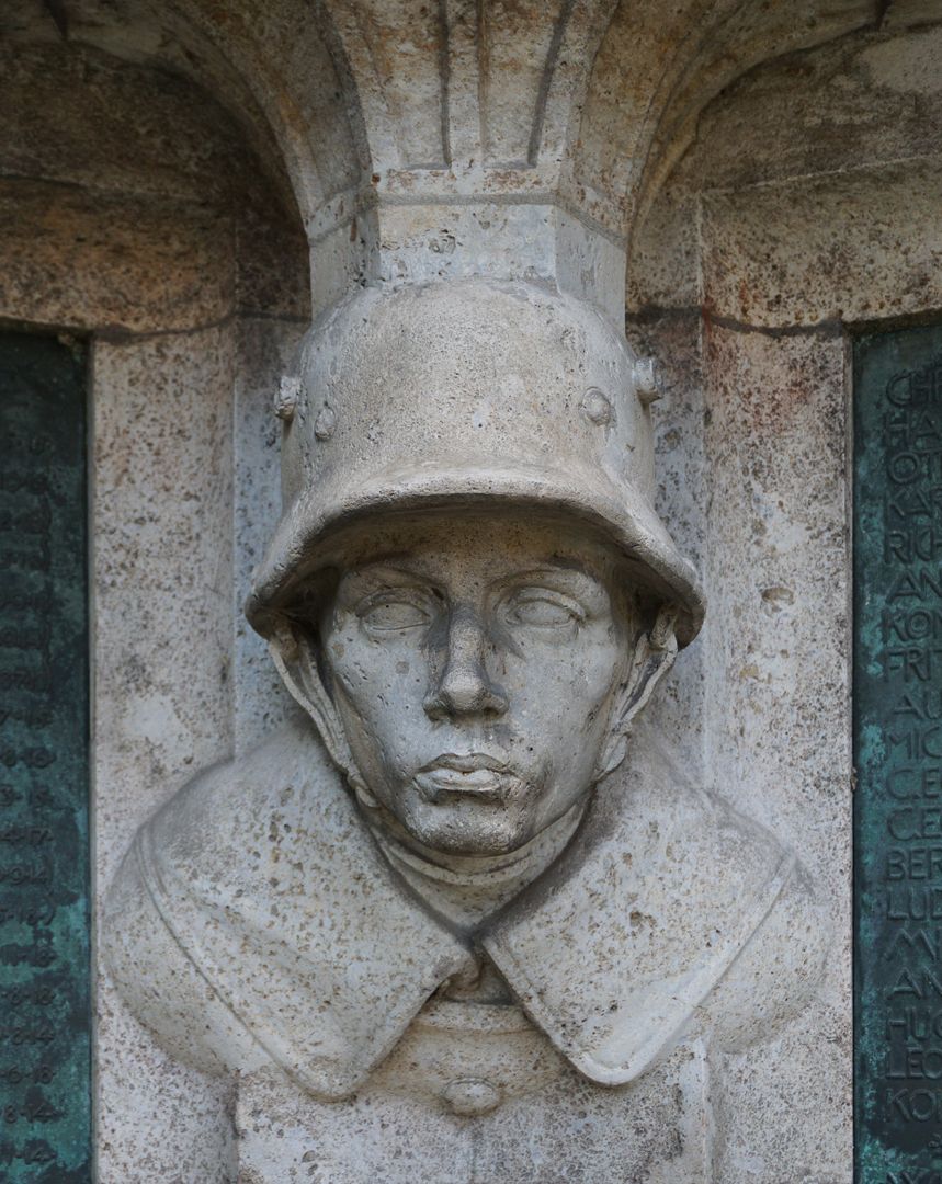 Kriegerdenkmal Soldat mit Stahlhelm aus dem sich die Konsole für die darüberliegende Kreuzigungsgruppe bildet, Frontalansicht